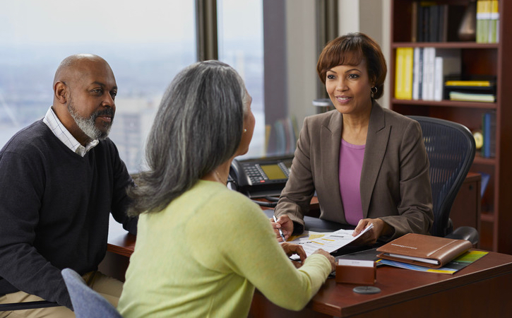 An older couple speaks with a financial advisor.