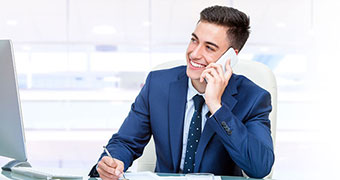 A male employee talking on a mobile phone