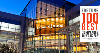 Exterior shot of an Edward Jones glass building at night.